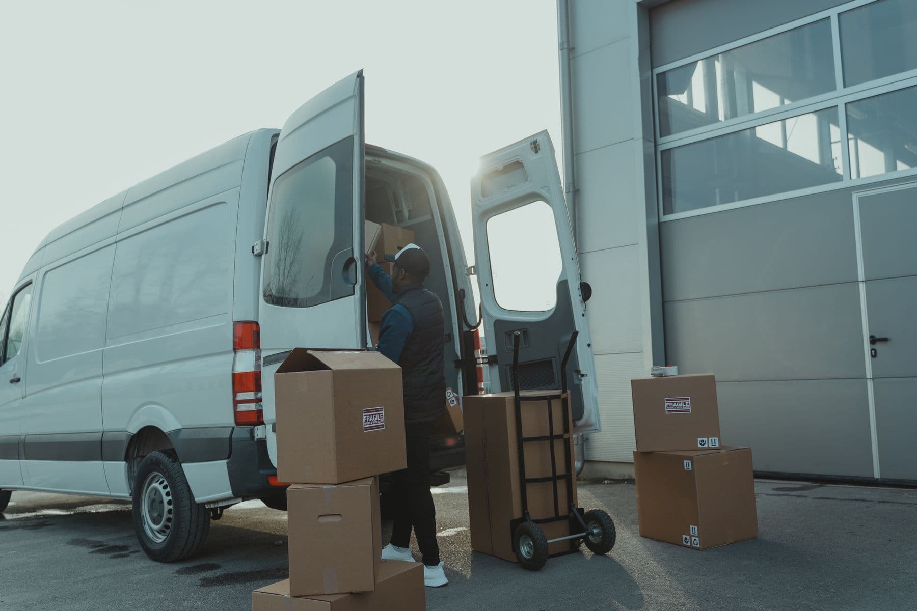 Global courier team loading parcels into a delivery vehicle